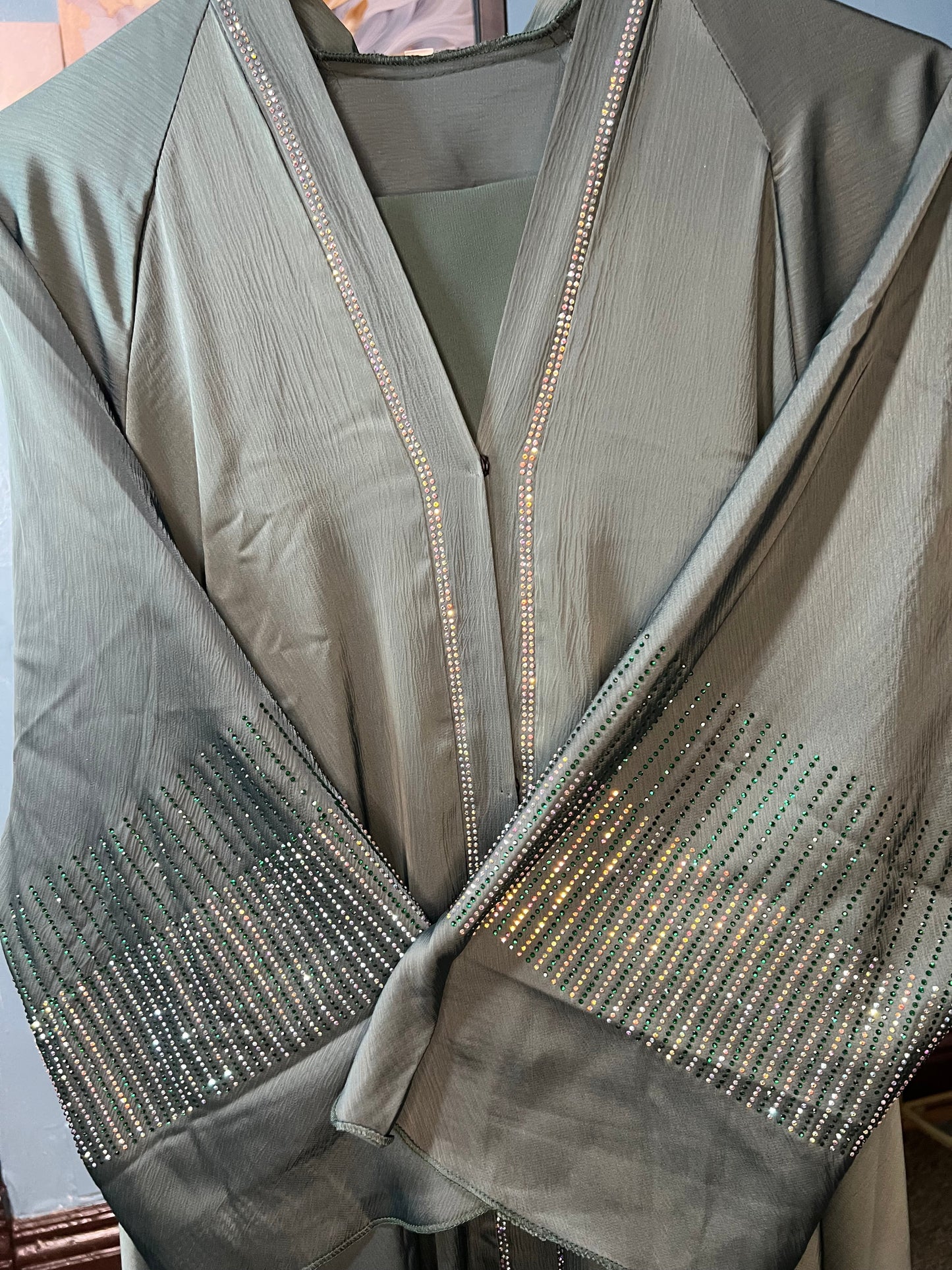 Teal-colored abaya with intricate rhinestone