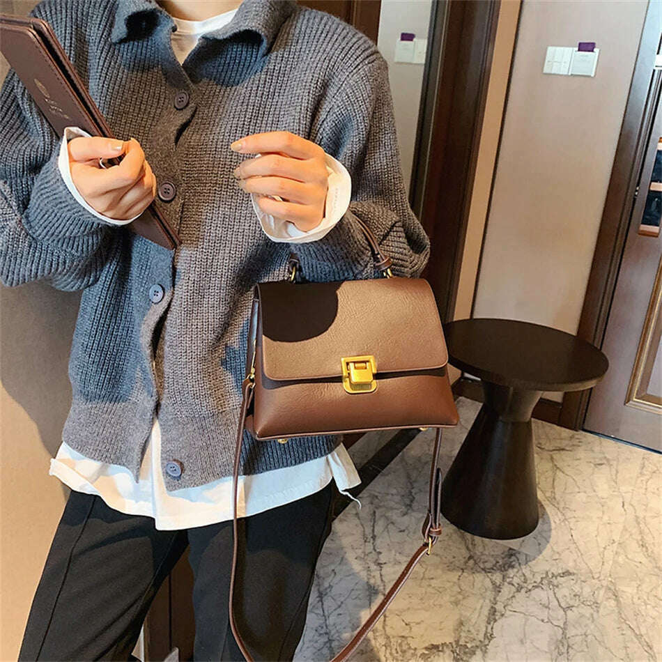 Chic Leather Top-Handle Bag with Gold Lock Closure