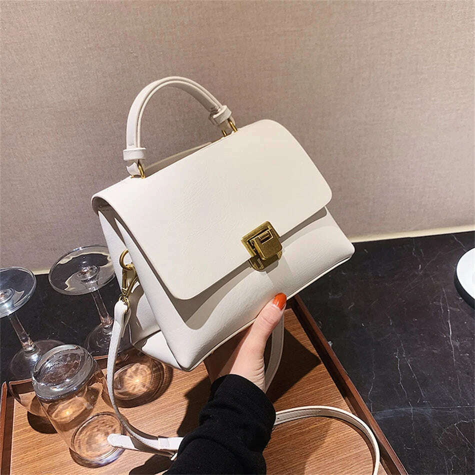 Chic Leather Top-Handle Bag with Gold Lock Closure
