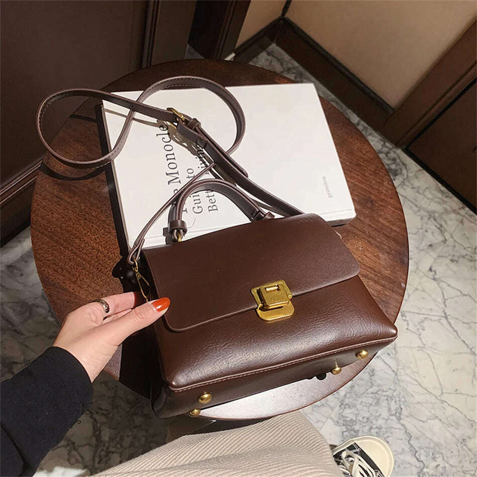 Chic Leather Top-Handle Bag with Gold Lock Closure