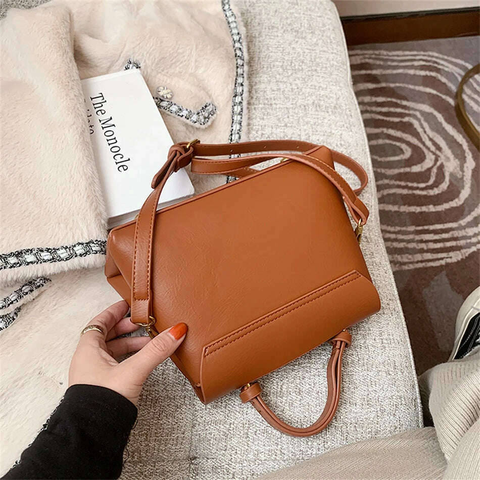 Chic Leather Top-Handle Bag with Gold Lock Closure