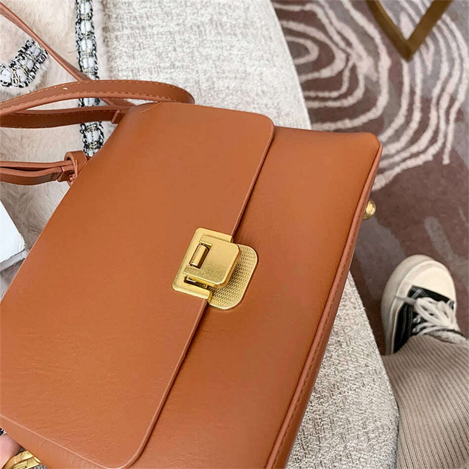 Chic Leather Top-Handle Bag with Gold Lock Closure