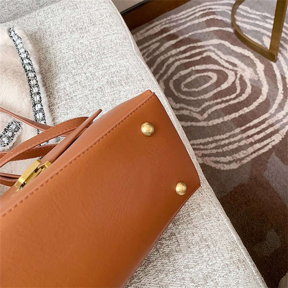 Chic Leather Top-Handle Bag with Gold Lock Closure