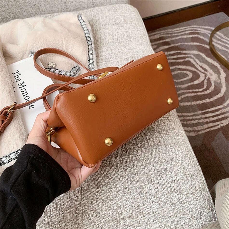 Chic Leather Top-Handle Bag with Gold Lock Closure