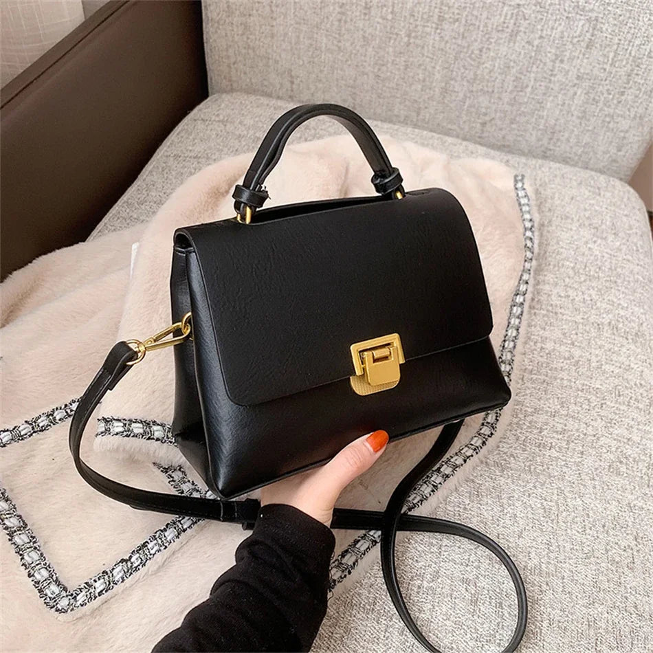 Chic Leather Top-Handle Bag with Gold Lock Closure