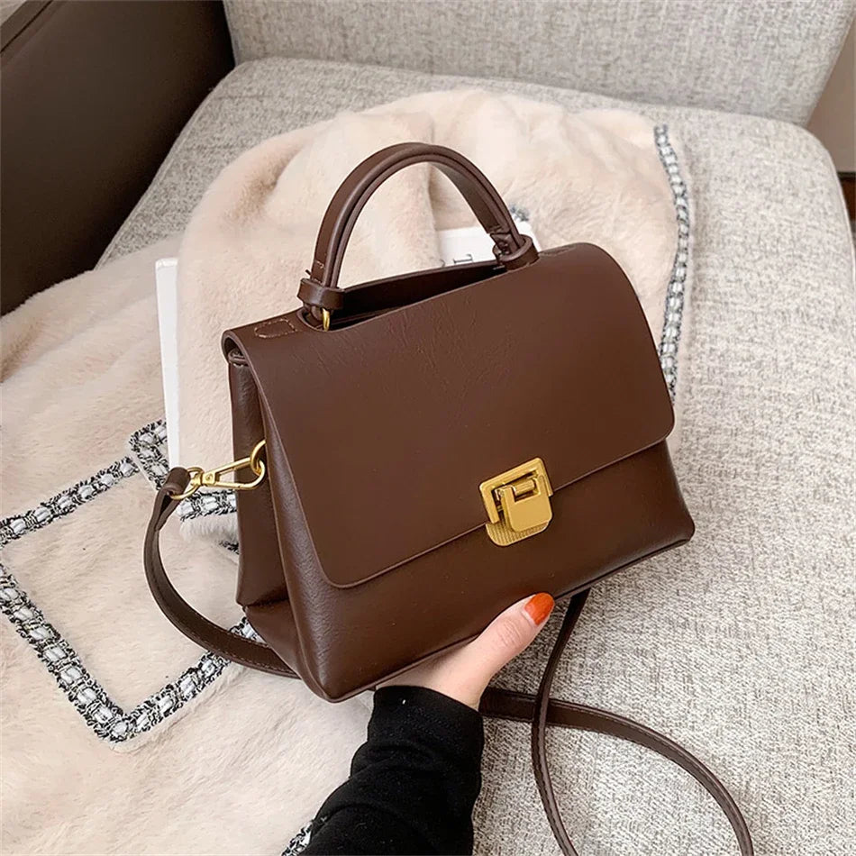 Chic Leather Top-Handle Bag with Gold Lock Closure