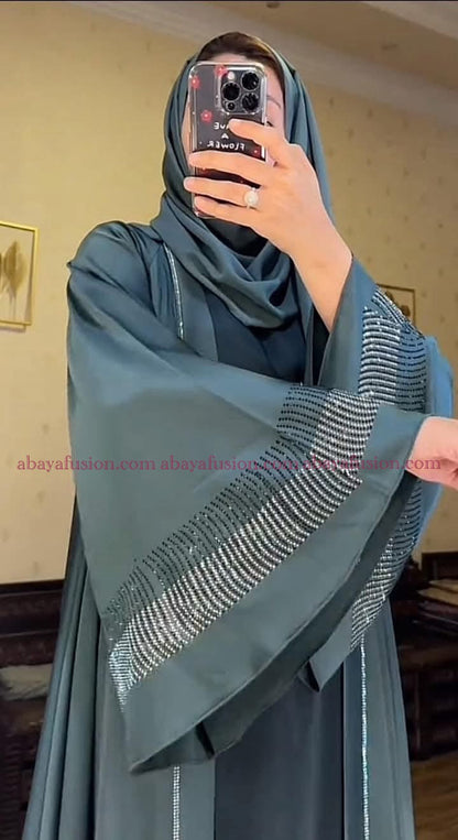 Teal-colored abaya with intricate rhinestone