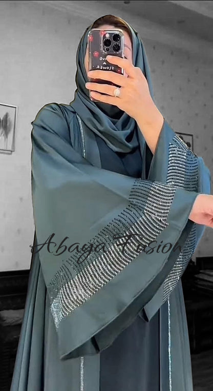 Teal-colored abaya with intricate rhinestone